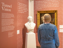 Load image into Gallery viewer, A woman with blonde hair viewing a white marble bust of the 5th Duke of Portland in the exhibition, Tunnel Vision, showing at The Harley Gallery.
